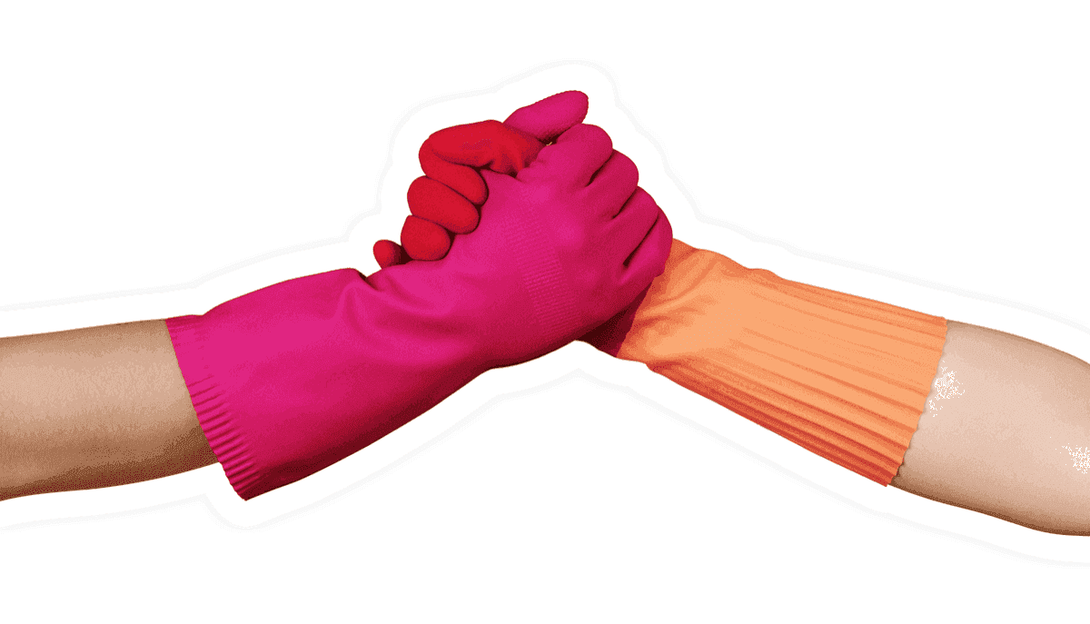 A handshake between two hands wearing cleaning gloves.