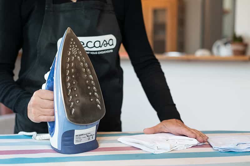 Housekeeper folding an ironed t-shirt