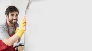 man cleaning a wall