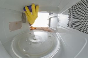 Cleaning the inside of the microwave in the home kitchen. The device for heating dishes with the help of waves.