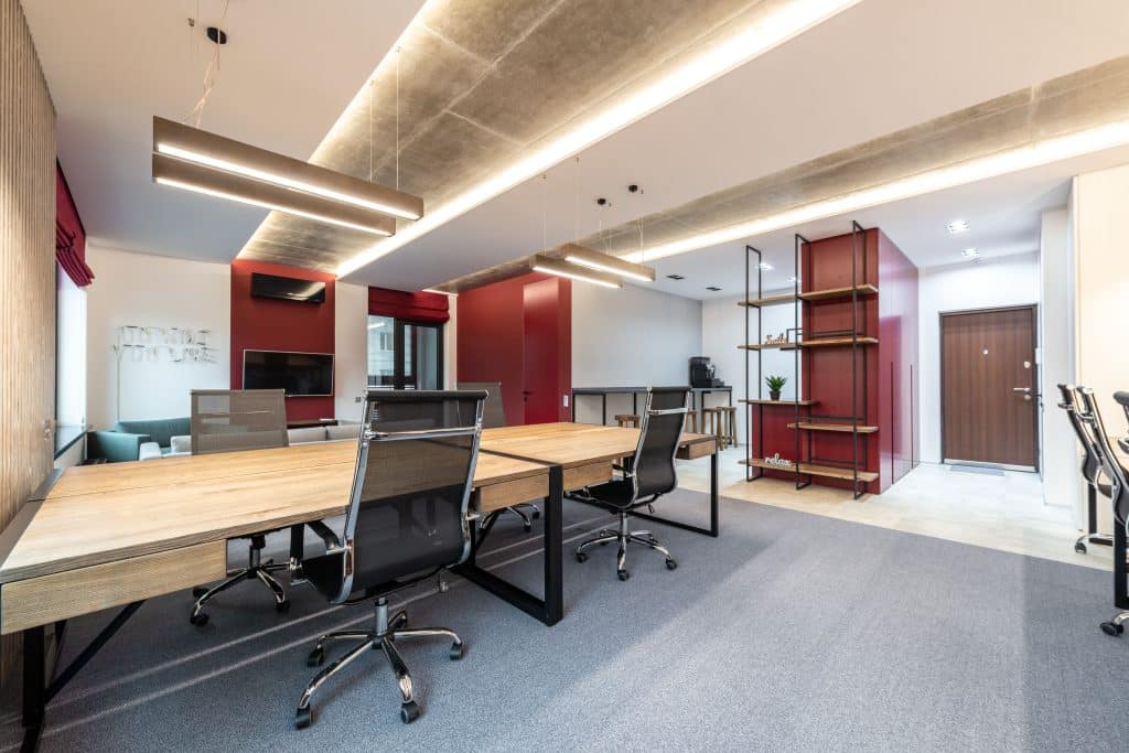 Clean London Office interior with table and chairs near shelves