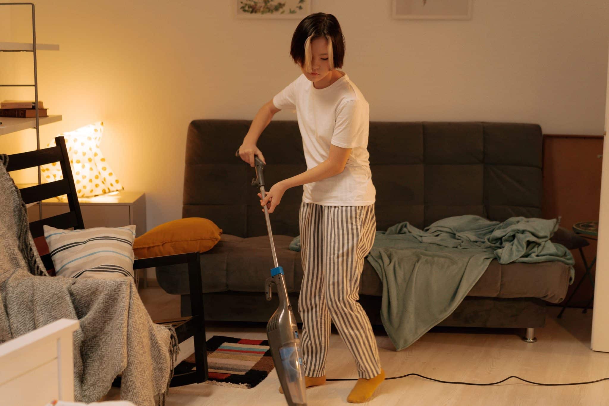 man vacuum cleaning apartment