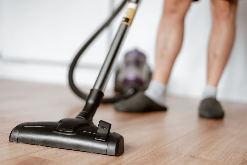 man cleaning floor with vacuum- home fresh