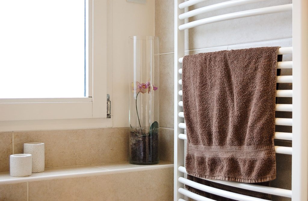 brown towel on a hanger-how often should you wash your towels