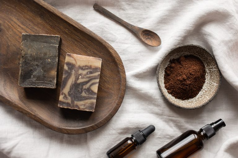 handmade soap and bowl with coffee placed on table