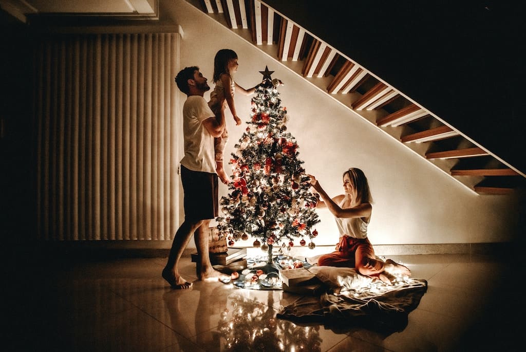 family decorating christmas tree