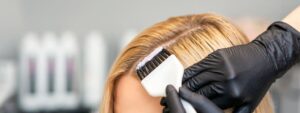 Professional stylist bleaching hair