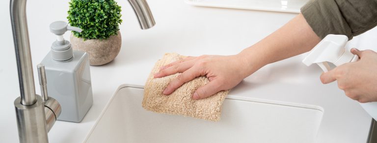 Woman is doing the spring cleaning at home kitchen.