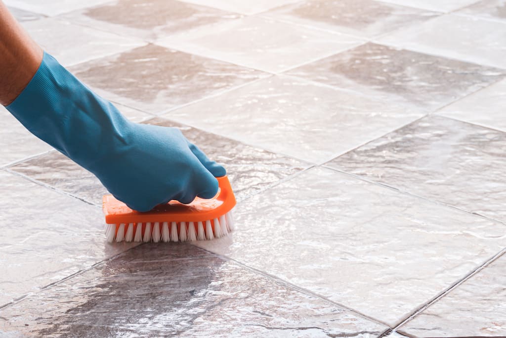 cleaning tile grout with bristled-brush