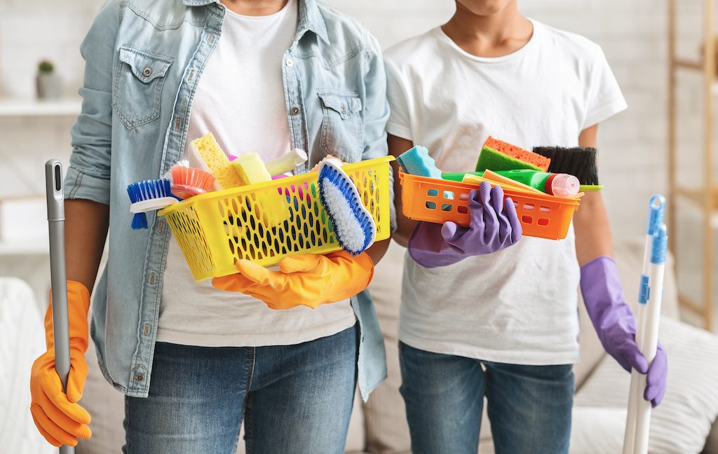 Man and woman both holding cleaning tools