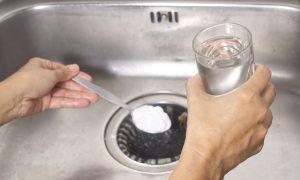 pour a spoon of baking soda and a glass of vinegar respectively into the drain of sink ,kitchen tips for effectively get rid of unpleasant smell
