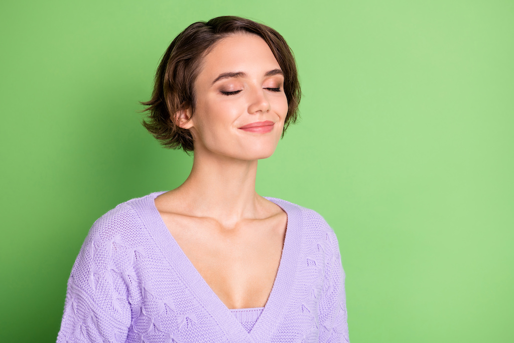 oung girl closed eyes smile enjoying smell